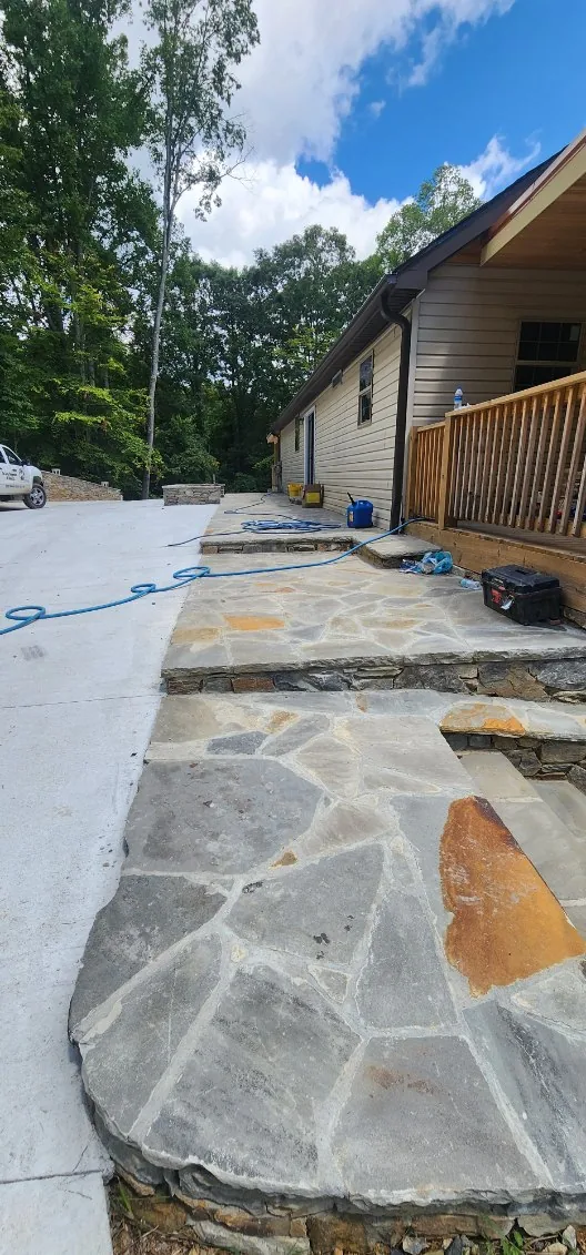 Flagstone landing and steps tying a concrete pad to the porch